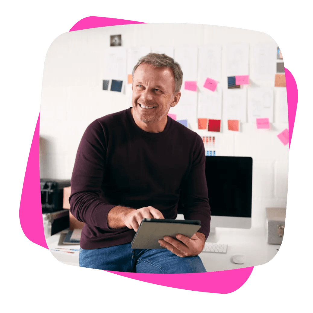 man with tablet sitting on desk