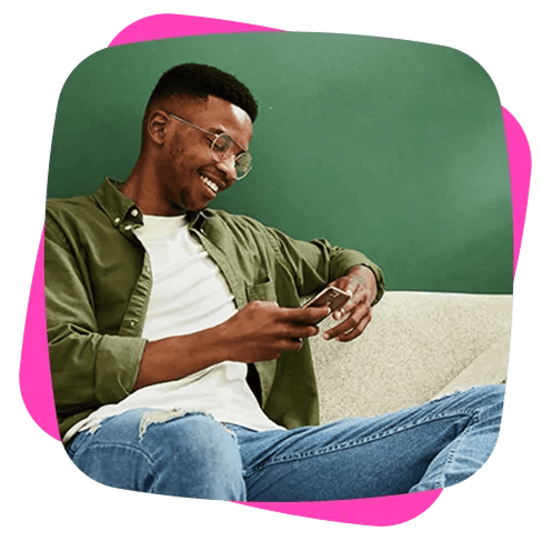 man on couch with mobile phone